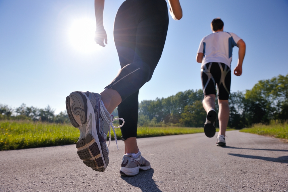 Young couple jogging in park at morning. Health and fitness.